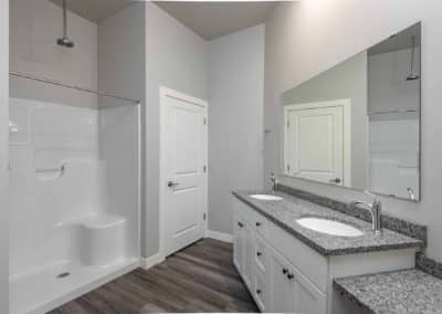 Granite double-vanity sink with extended sit-at area in THE CURRENT apartments