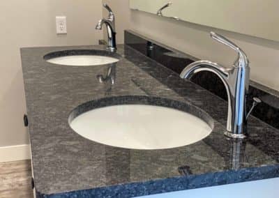 Granite double-vanity sink with extended sit-at area in THE CURRENT apartments
